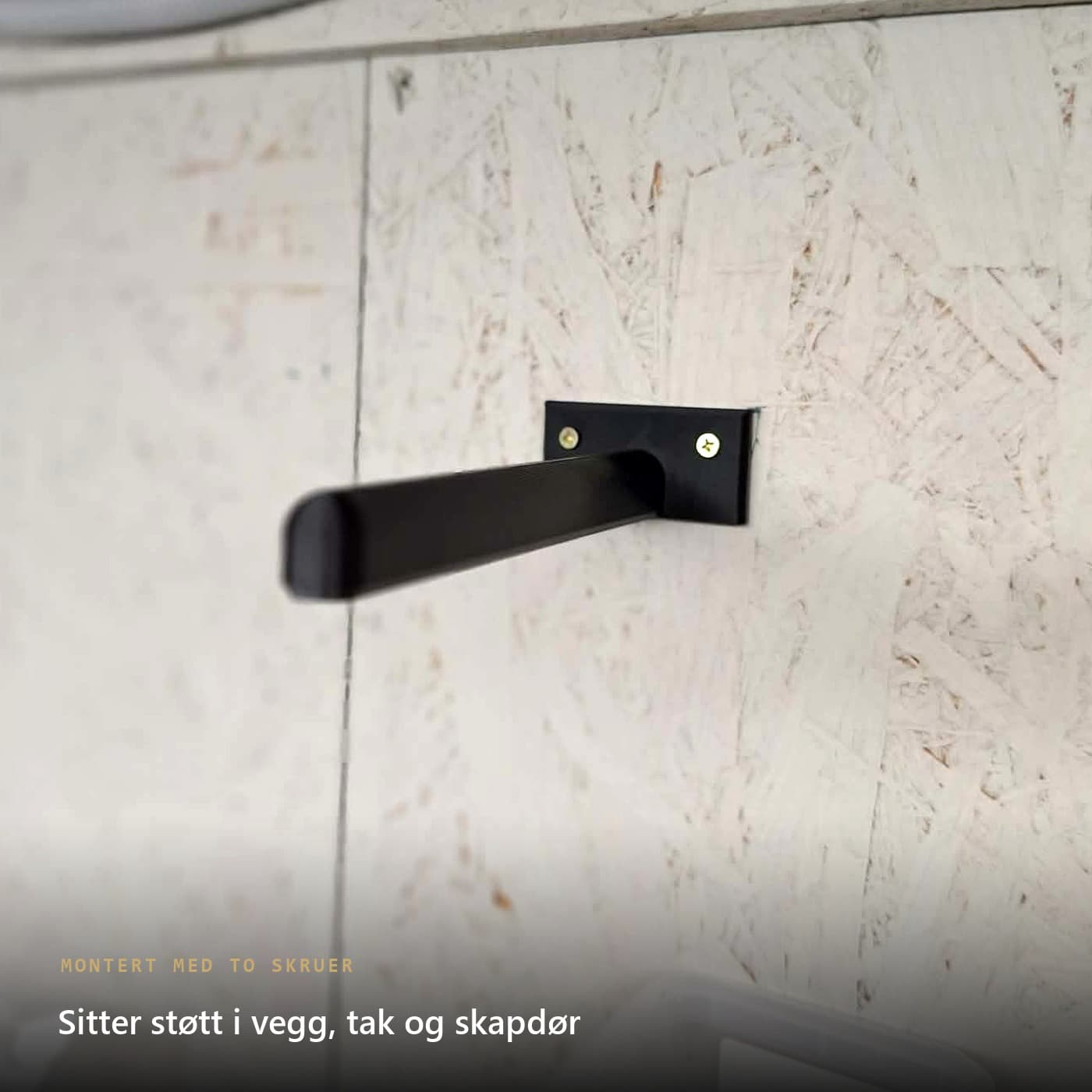 Teipholder skrudd fast i vegg med to skruer